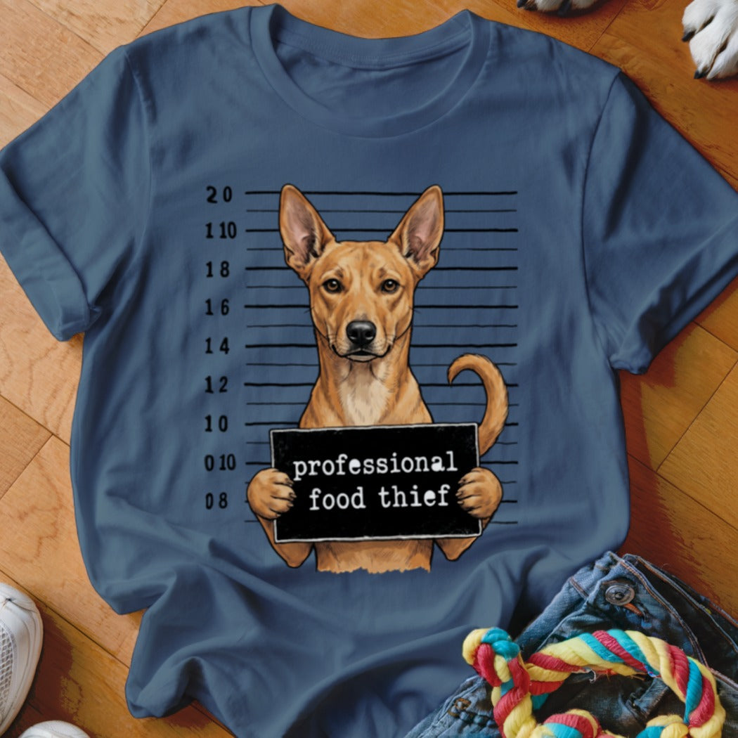 Dog mugshot with sign reading "professional food thief"