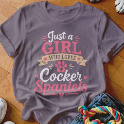 T-shirt with text "Just a girl who loves Cocker Spaniels" and paw print graphic.