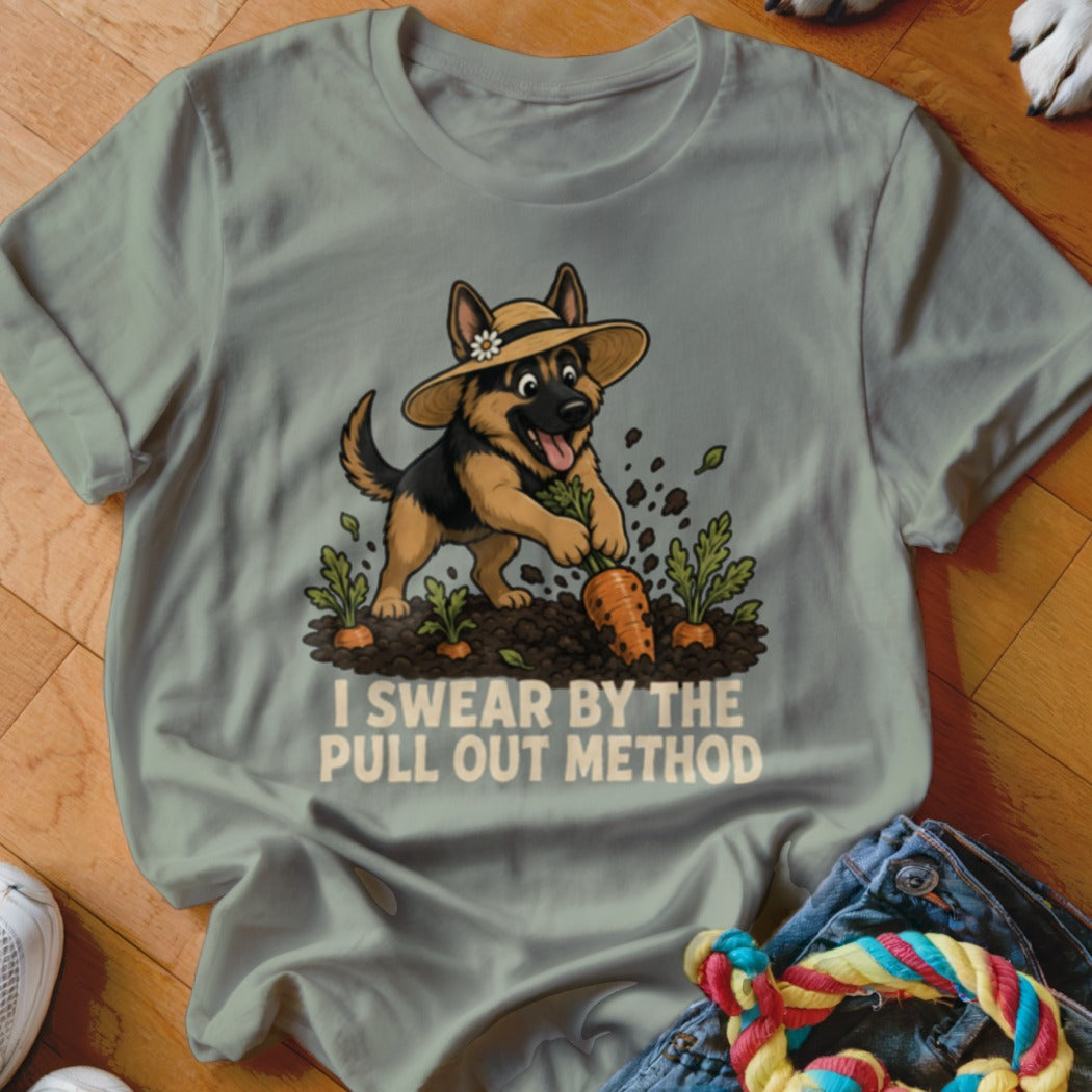 German Shepherd dog in hat pulls carrot from garden with text "I SWEAR BY THE PULL OUT METHOD."