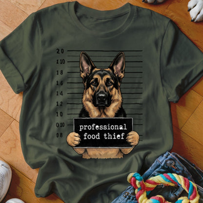 German Shepherd in mugshot holding "professional food thief" sign