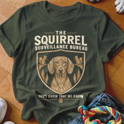 Dark green t-shirt featuring a dachshund graphic with text reading The Squirrel Surveillance Bureau.