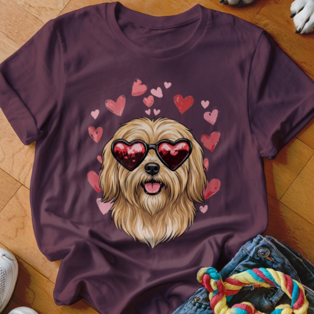 Maroon t-shirt featuring a graphic of a shaggy blonde dog wearing heart-shaped sunglasses surrounded by floating pink hearts.
