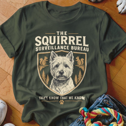 Dark green t-shirt featuring a West Highland White Terrier graphic with the text The Squirrel Surveillance Bureau.