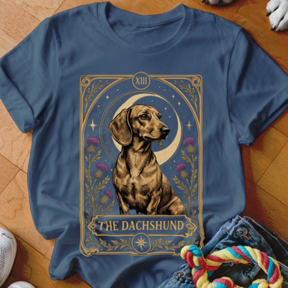 A dark blue crewneck t-shirt featuring a tarot card style graphic of a dachshund.