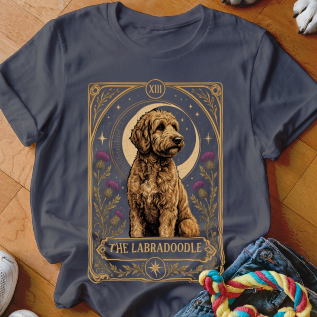 Dark grey t-shirt featuring a tarot card graphic with a golden Labradoodle and purple thistles.