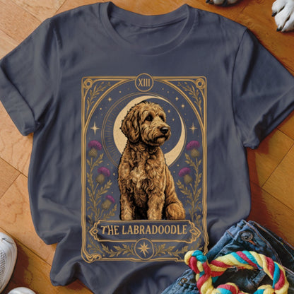 Dark grey t-shirt featuring a tarot card graphic with a golden Labradoodle and purple thistles.