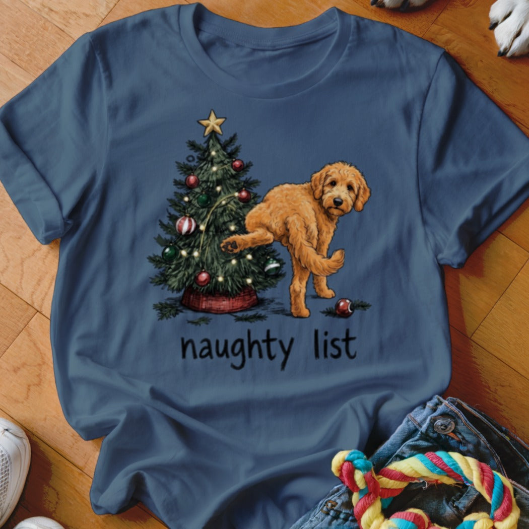 Goldendoodle dog by Christmas tree with text "naughty list".