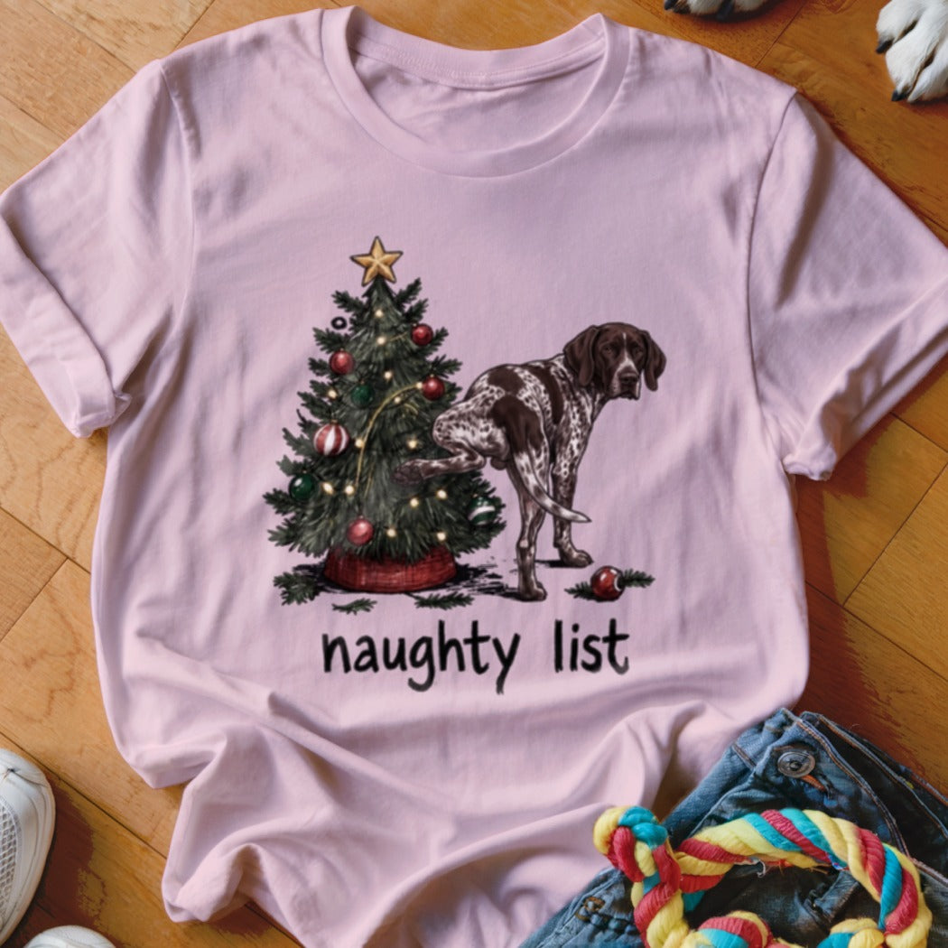 German Shorthaired Pointer lifting leg on Christmas tree with "naughty list" text.