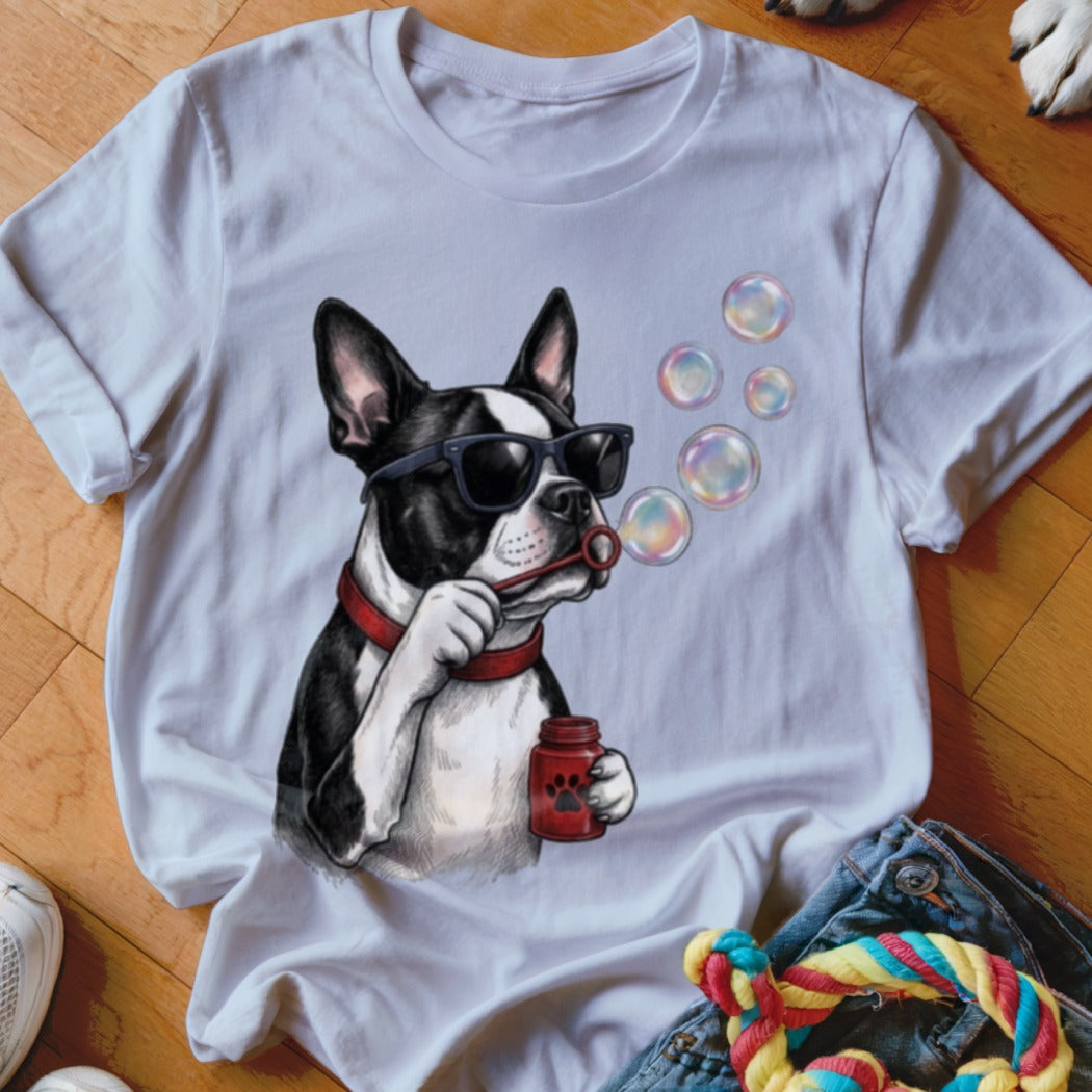 A white t-shirt featuring a graphic of a Boston Terrier blowing bubbles.