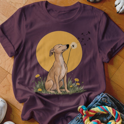 A dark purple t-shirt features a graphic of a dog blowing dandelion seeds against a yellow circle.