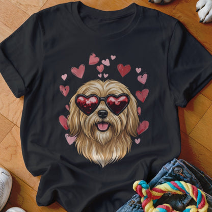 Black t-shirt featuring an illustration of a fluffy blonde dog wearing heart-shaped sunglasses, surrounded by pink hearts.
