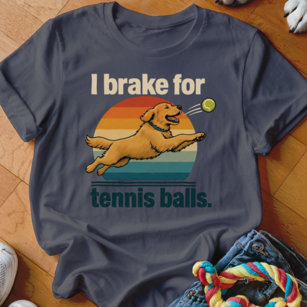 T-shirt with text "I brake for tennis balls" and a golden retriever jumping for a tennis ball.