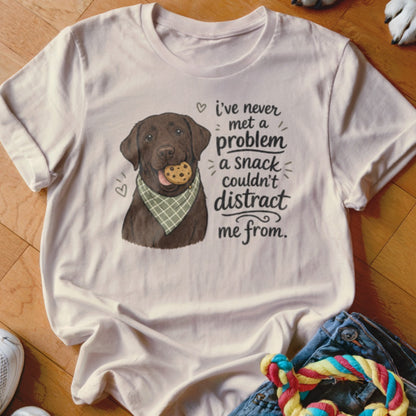Chocolate lab wearing bandana with cookie, text says "I've never met a problem a snack couldn't distract me from."