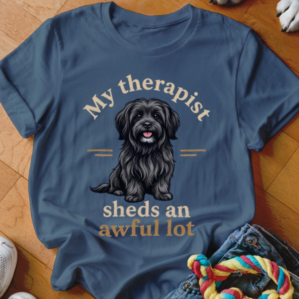 Blue t-shirt with a black dog illustration and text "My therapist sheds an awful lot".