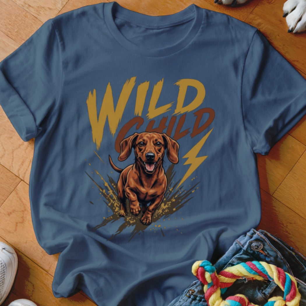 Blue crewneck t-shirt featuring a graphic of a running dachshund, mud splatters, and the text WILD CHILD.