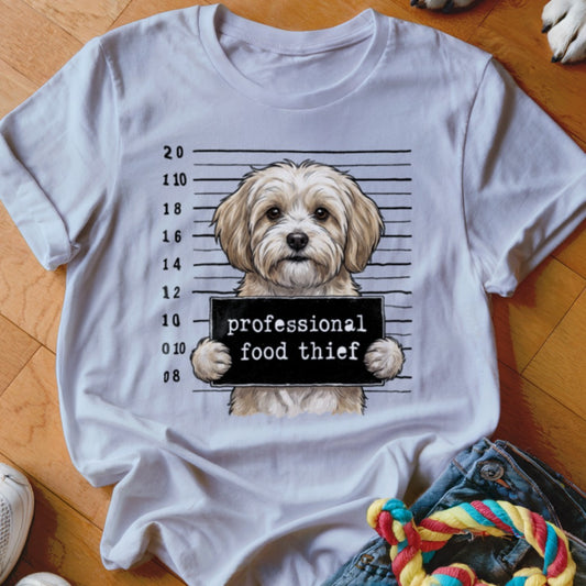White t-shirt with a drawing of a dog holding a "professional food thief" sign.