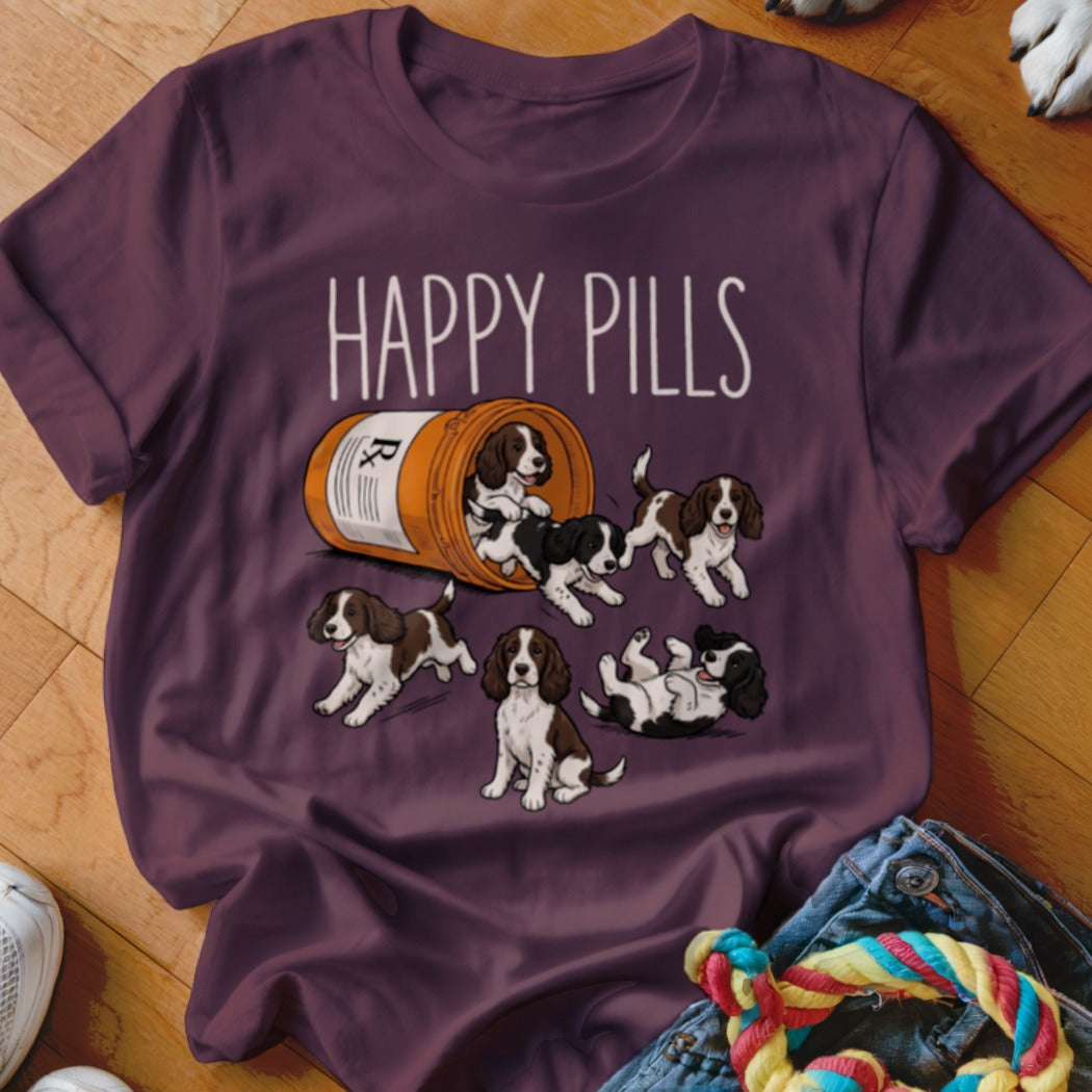 T-shirt with "HAPPY PILLS" and cartoon puppies spilling from a pill bottle.