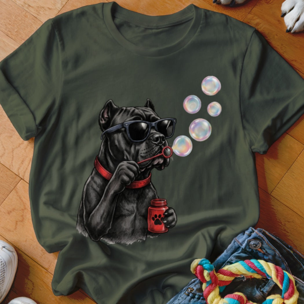 Olive green t-shirt featuring a graphic of a black dog wearing sunglasses and blowing bubbles.