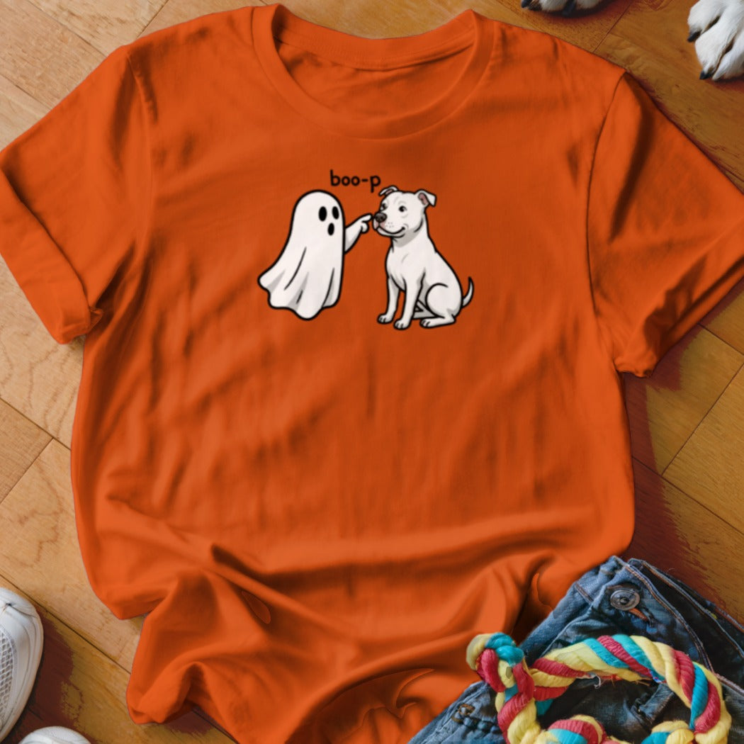 Orange t-shirt with cartoon ghost booping white dog with text "boo-p".