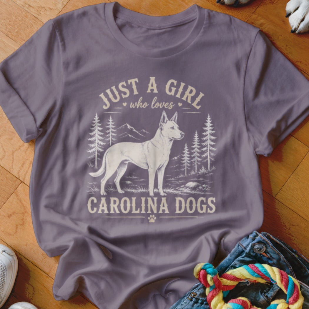 T-shirt with graphic of a Carolina Dog in a forest landscape. Text says "Just a girl who loves Carolina Dogs."