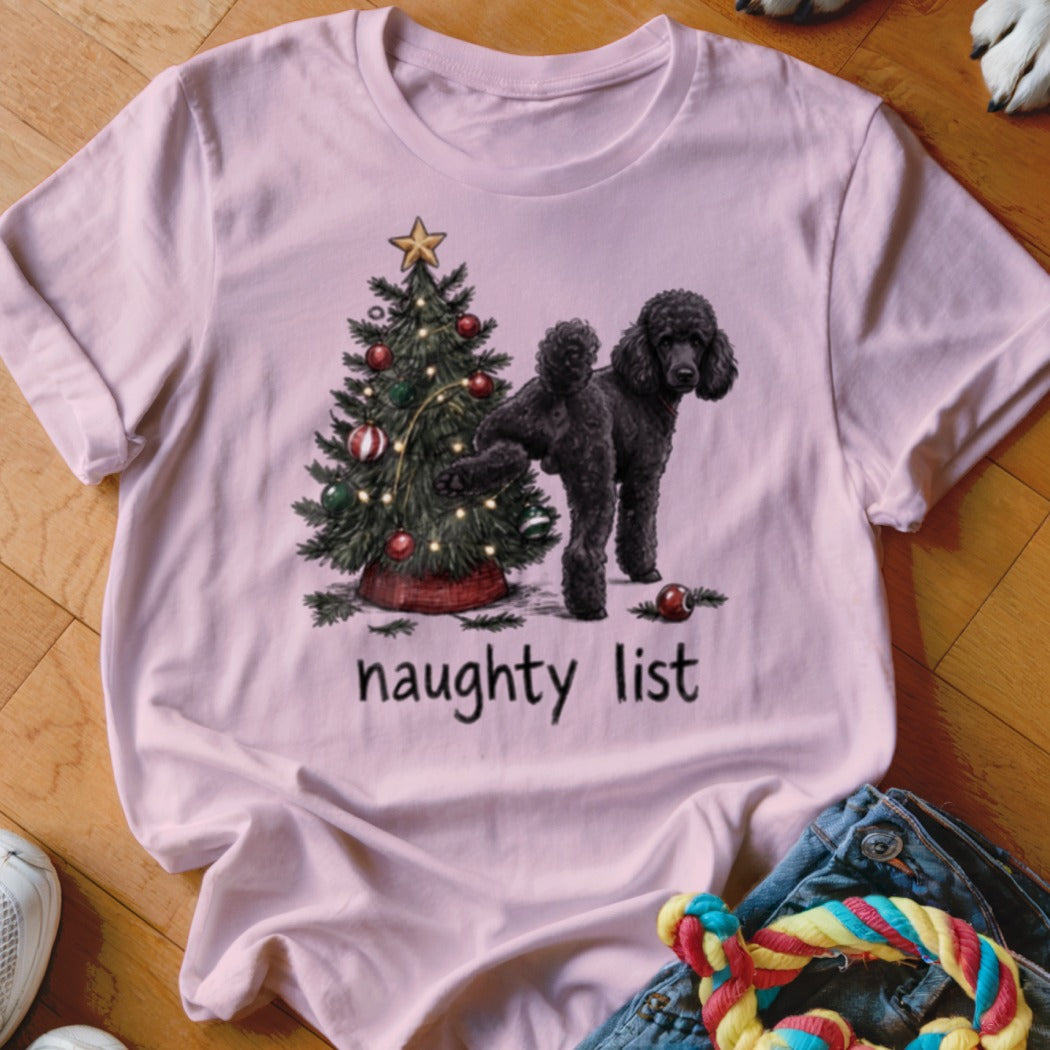 Pink t-shirt with a black poodle and Christmas tree graphic that reads "naughty list".