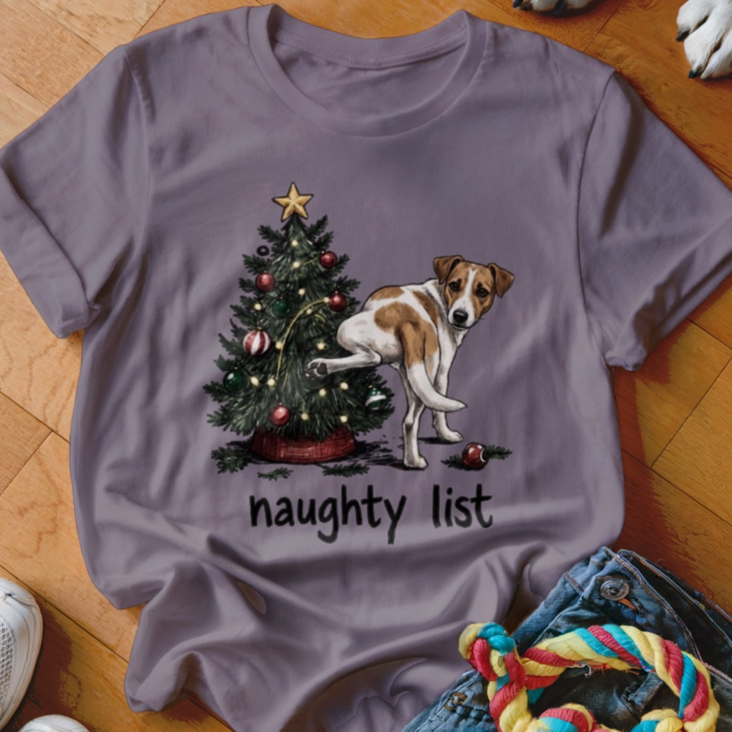 Dog lifting leg on Christmas tree with text "naughty list".