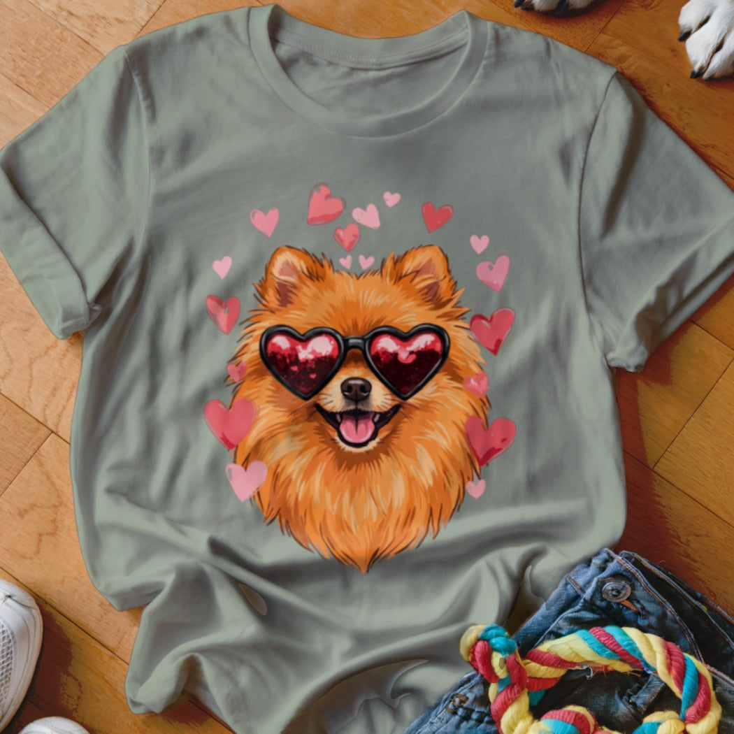 Sage green t-shirt featuring a Pomeranian wearing heart-shaped sunglasses surrounded by floating pink hearts.
