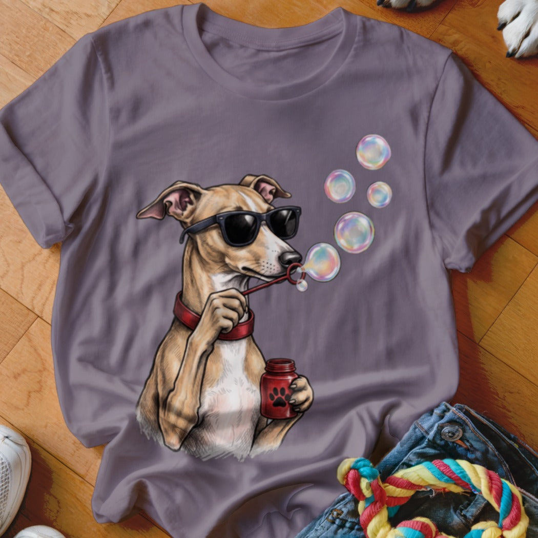 A purple t-shirt featuring an illustration of a dog wearing sunglasses and blowing soap bubbles.