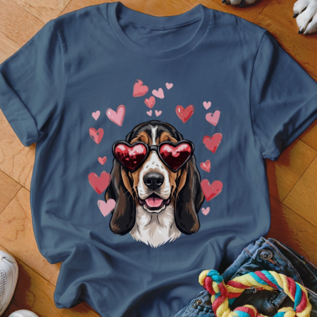 A slate blue crewneck t-shirt featuring a graphic of a basset hound wearing heart-shaped sunglasses surrounded by pink hearts.