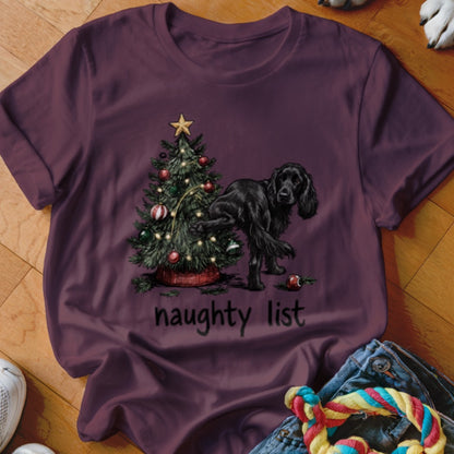 Black dog lifting leg on Christmas tree with text "naughty list".