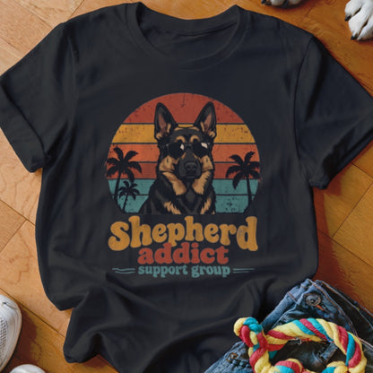 Black t-shirt featuring a German Shepherd wearing sunglasses in front of a retro sunset and palm trees.