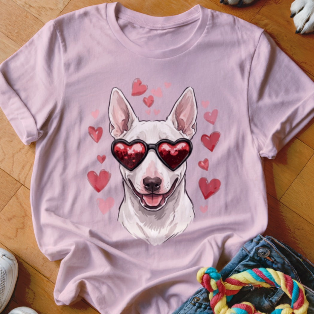 Light pink t-shirt featuring a white dog wearing heart-shaped sunglasses, surrounded by pink hearts.