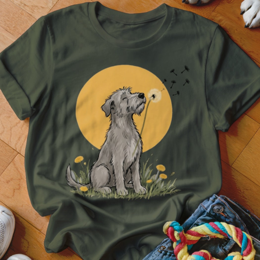 A dark green t-shirt featuring a graphic of a gray dog blowing dandelion seeds.