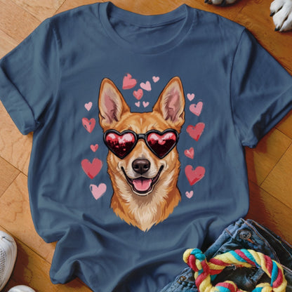 A dark blue t-shirt printed with an illustration of a smiling dog wearing heart-shaped sunglasses surrounded by pink hearts.