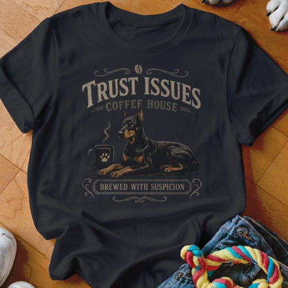 Black t-shirt with "Trust Issues Coffee House" and a Doberman next to a steaming mug.