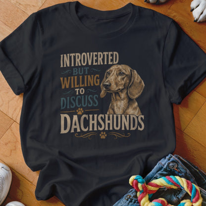 Black t-shirt with "Introverted But Willing to Discuss Dachshunds" text and a dachshund illustration.