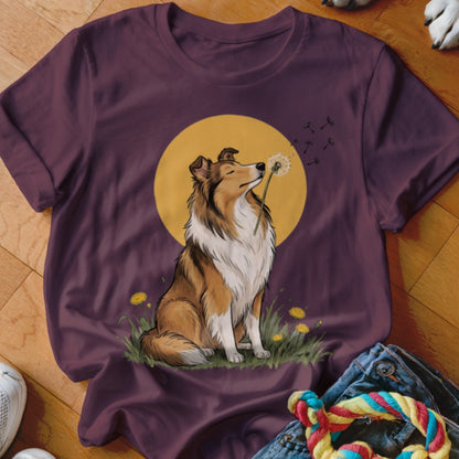 Plum t-shirt featuring an illustrated Rough Collie sitting in grass and blowing a dandelion against a yellow sun.