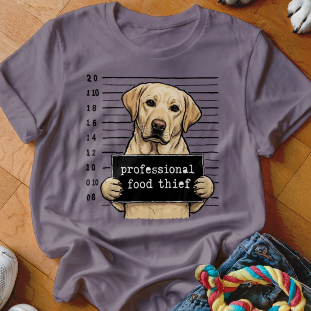 Yellow lab dog mugshot sign reads "professional food thief"
