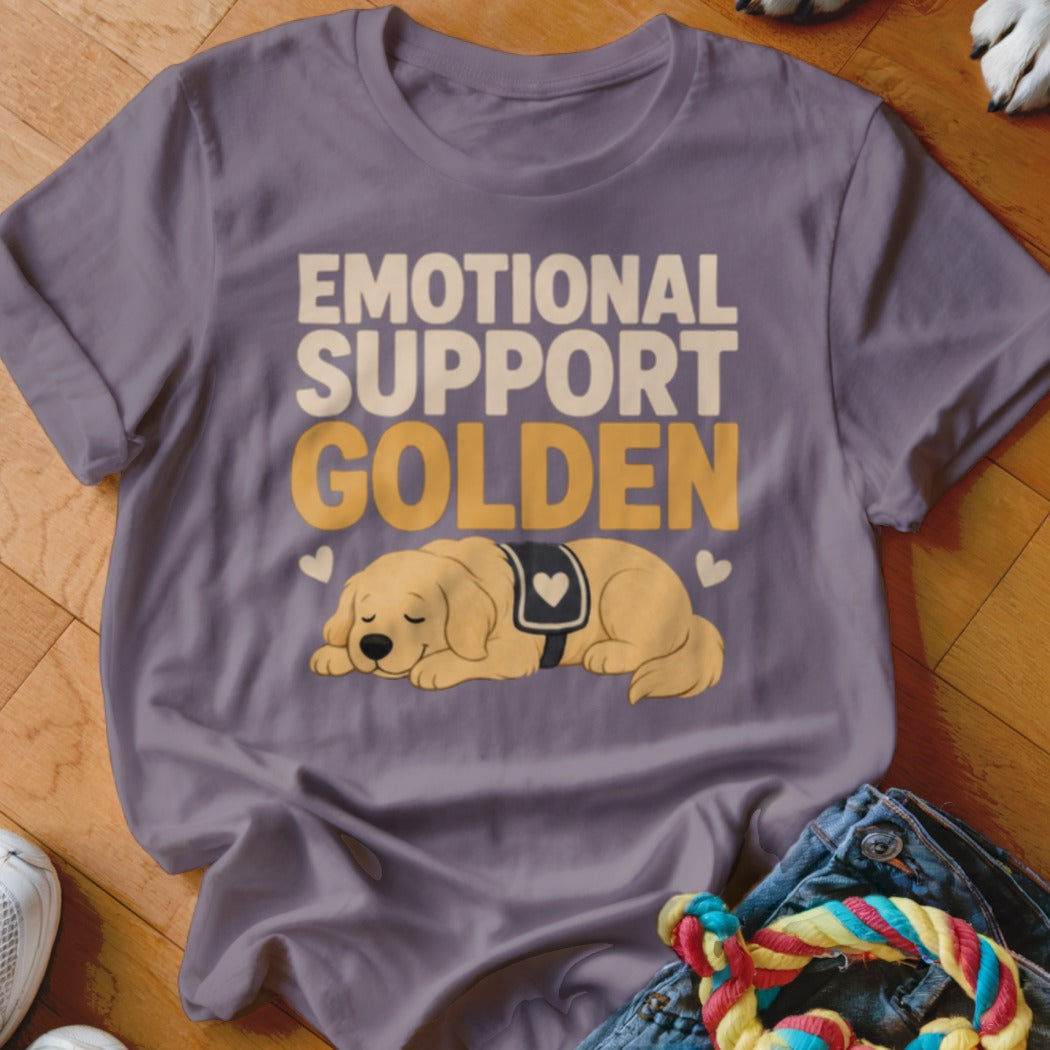 A purple crewneck t-shirt featuring the text Emotional Support Golden and an illustration of a sleeping golden retriever.