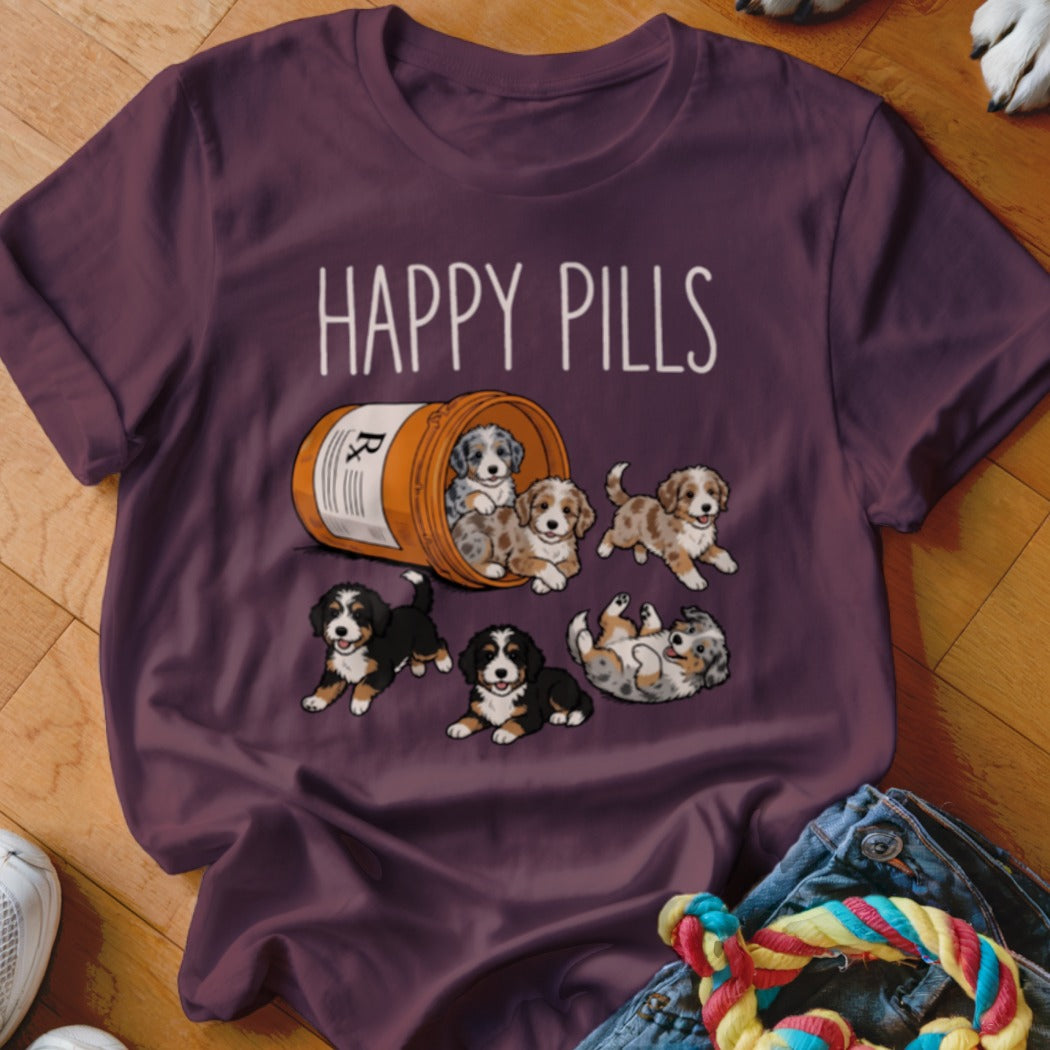T-shirt with a graphic of puppies spilling out of a pill bottle, text reads "HAPPY PILLS".