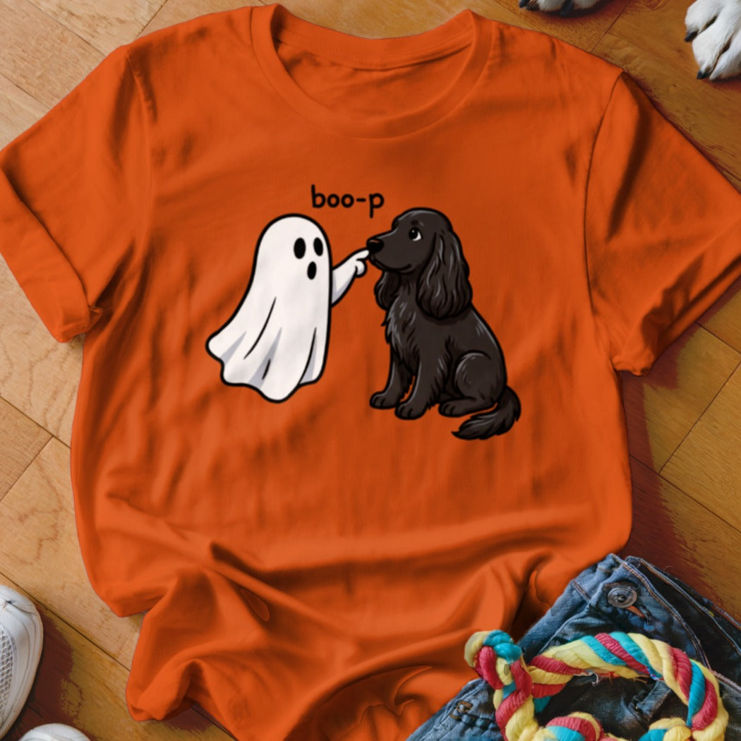 Orange t-shirt with a cartoon ghost booping a black dog with the text "boo-p".