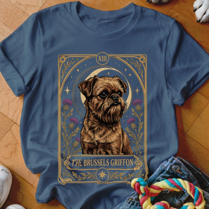 A navy blue t-shirt displays a graphic of a Brussels Griffon framed like a tarot card.
