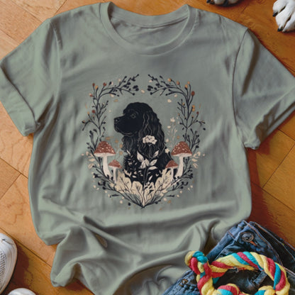 Sage green crewneck t-shirt featuring a black cocker spaniel surrounded by mushrooms and botanical illustrations.