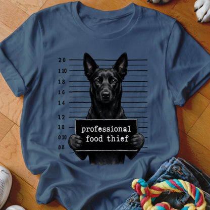 Black dog in mugshot with "professional food thief" sign.