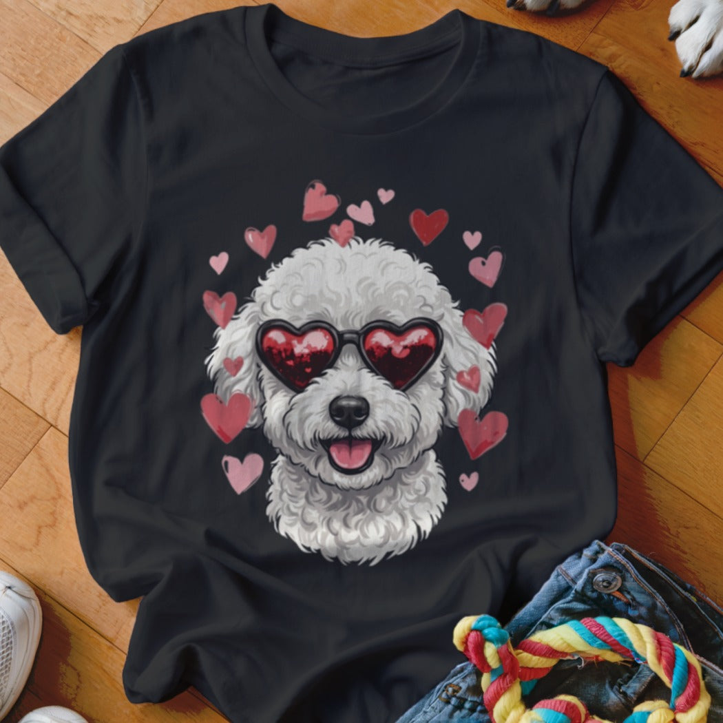 A black crewneck t-shirt featuring a graphic of a fluffy white dog wearing heart-shaped sunglasses, surrounded by pink and red hearts.