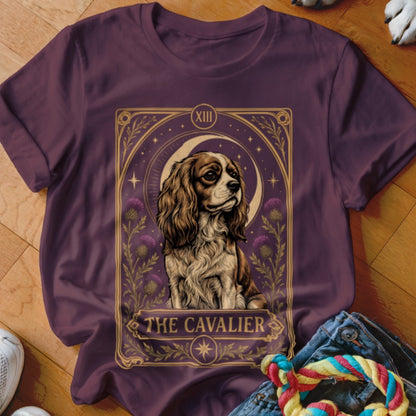 Purple crewneck t-shirt featuring a tarot card graphic of a Cavalier King Charles Spaniel with the text "The Cavalier".