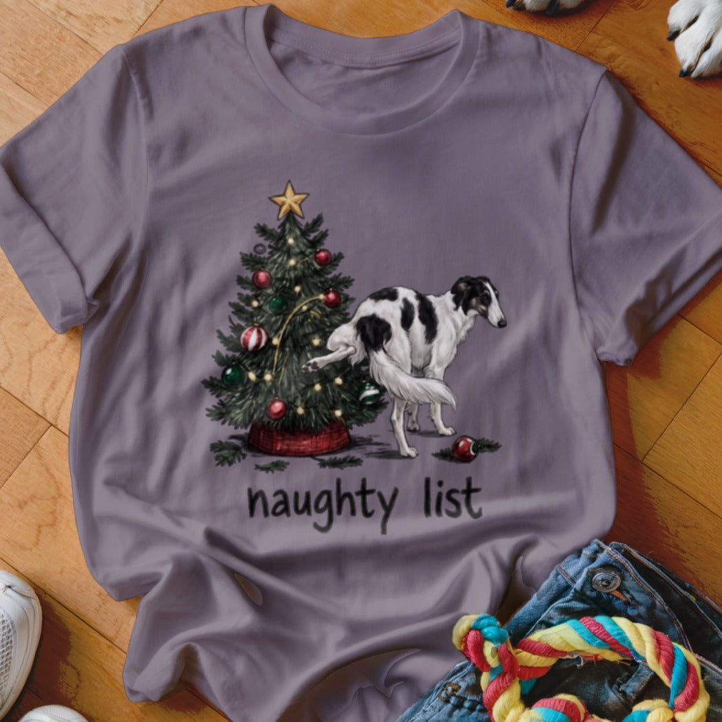 A grey t-shirt featuring a graphic of a dog lifting its leg on a Christmas tree, with the text "naughty list" below.