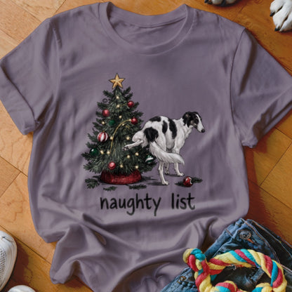 A grey t-shirt featuring a graphic of a dog lifting its leg on a Christmas tree, with the text "naughty list" below.