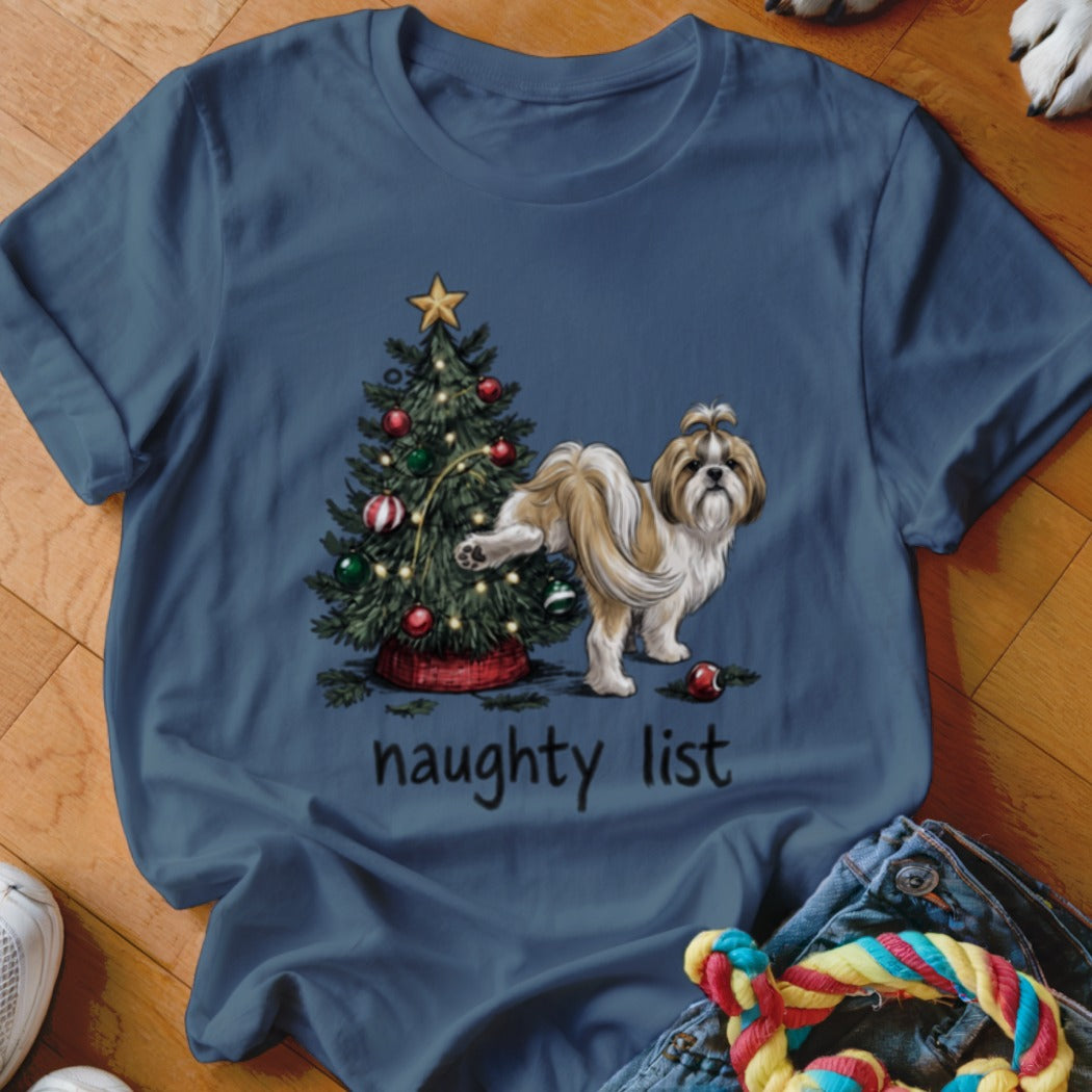 A dark blue t-shirt displays an illustration of a dog urinating on a Christmas tree with the text naughty list.