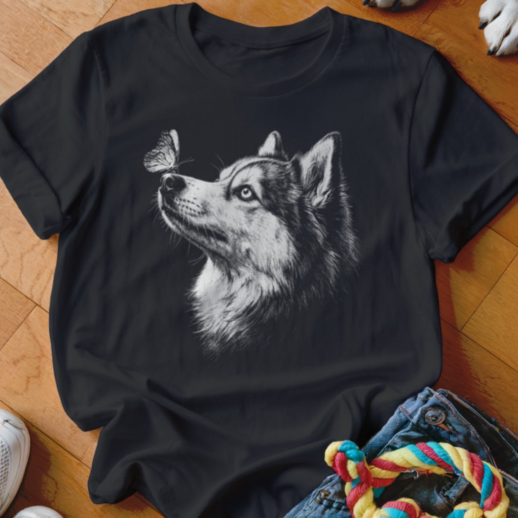 Black crewneck t-shirt featuring a white sketch graphic of a husky looking at a butterfly.